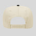 Beige cap with a black button on a light gray background
